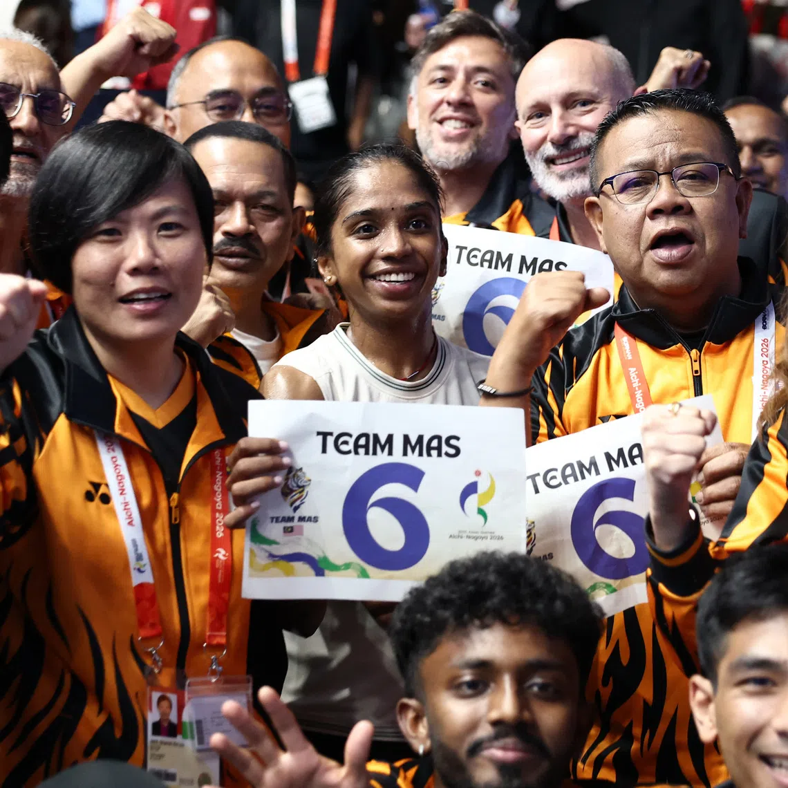 Asian Games - Aichi-Nagoya 2026 - Squash - Takeda Teva Ocean Arena, Nagoya, Japan - September 27, 2026 Malaysia's Sivasangari Subramaniam celebrates with teammates after winning the Women's Singles Gold Medal Match against India's Anahat Singh REUTERS/Chalinee Thirasupa