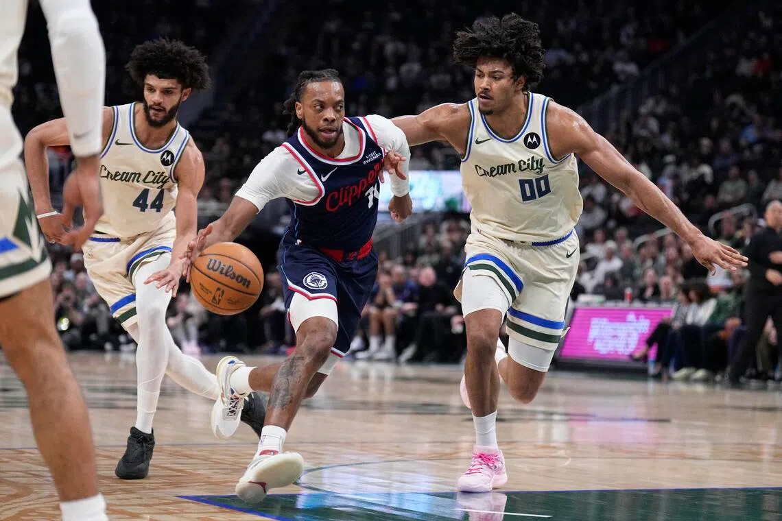 LA Clippers guard Darius Garland drives against Milwaukee Bucks centre Jericho Sims in the first half at Fiserv Forum.