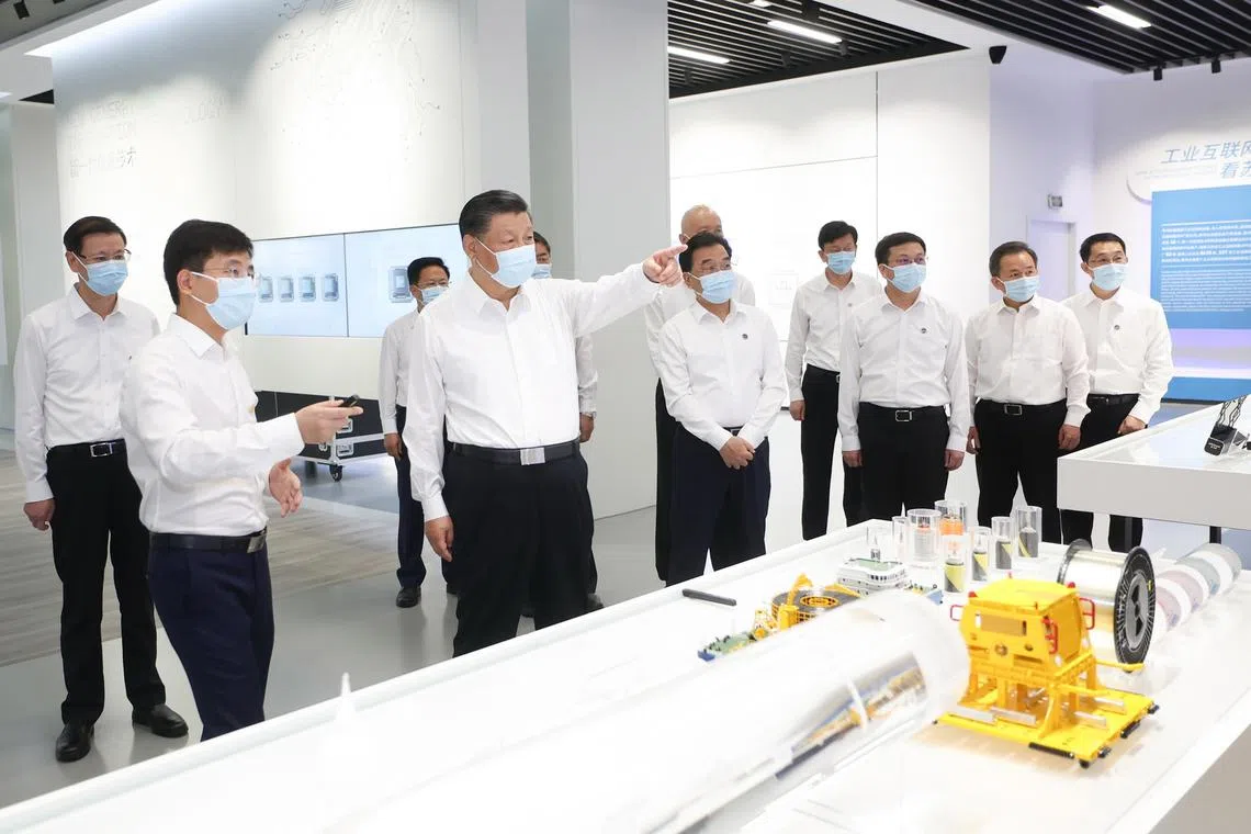 Mr Xi Jinping (4th left) visits the exhibition centre of the Suzhou Industrial Park in Suzhou, Jiangsu Province.