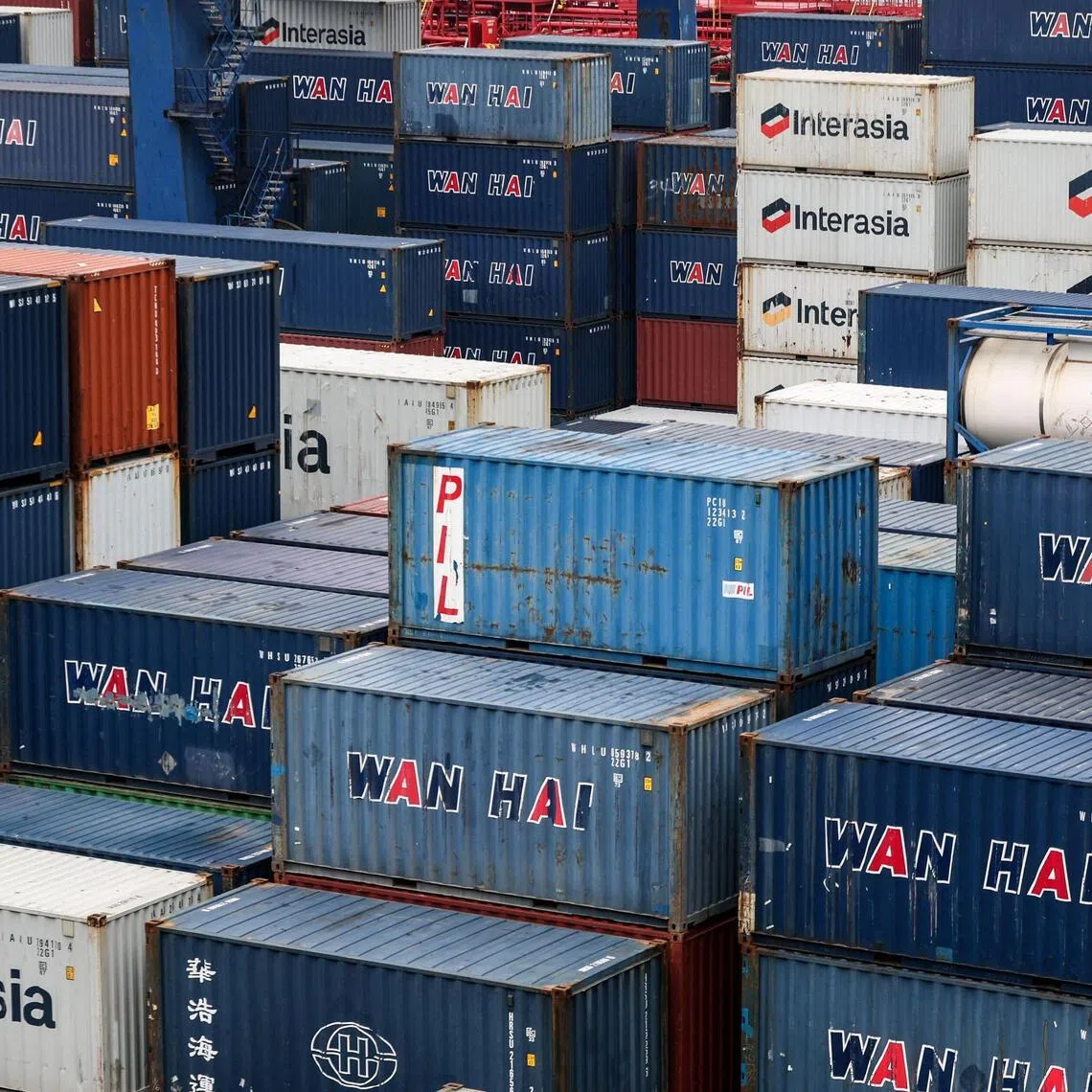 Shipping containers are seen at the port in Keelung on January 16, 2026. The United States said on January 15 that it has signed a deal with Taiwan to reduce tariffs on goods from the democratic island, while increasing Taiwanese semiconductor and tech companies' investments in America. (Photo by I-Hwa Cheng / AFP)