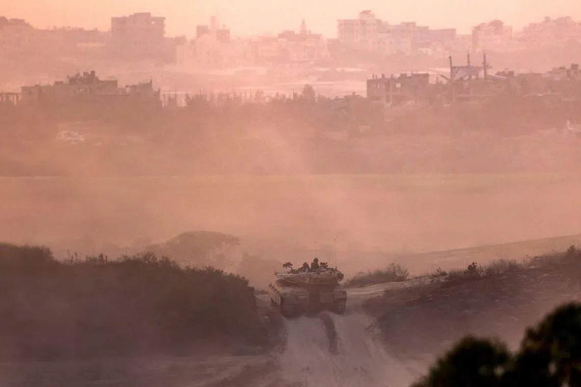 An Israeli tank drives near the border with Gaza Strip, in Israel, October 31, 2023. REUTERS/Amir Cohen