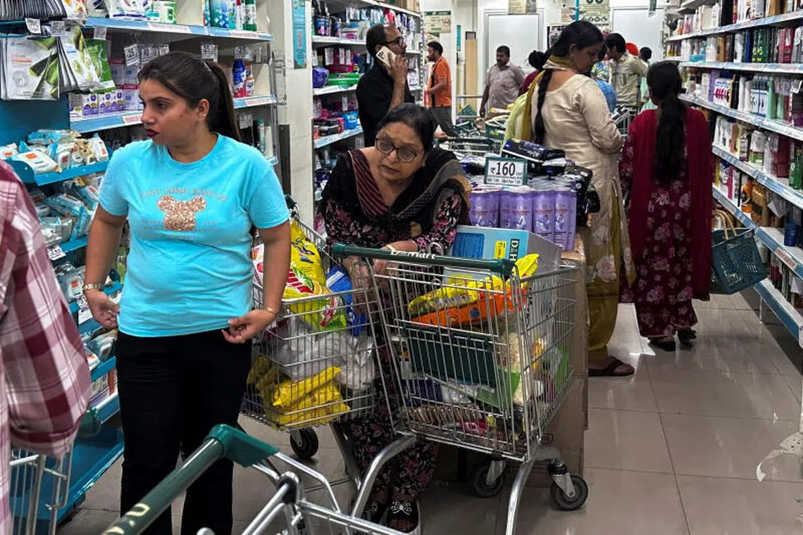 People shop for essential goods at a supermarket in Amritsar, India, May 9, 2025. REUTERS/Francis Mascarenhas