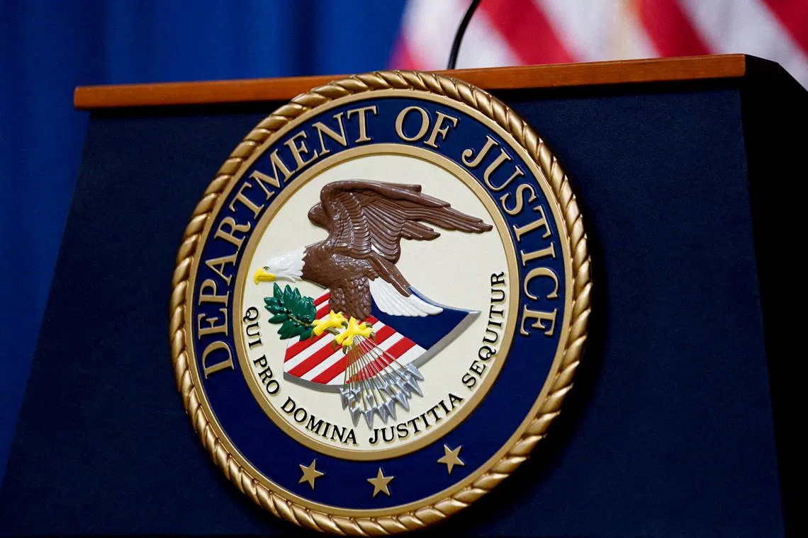 FILE PHOTO: The seal of the U.S. Justice Department is seen on the podium in the Department's headquarters briefing room before a news conference with the Attorney General in Washington, January 24, 2023. REUTERS/Kevin Lamarque/File Photo