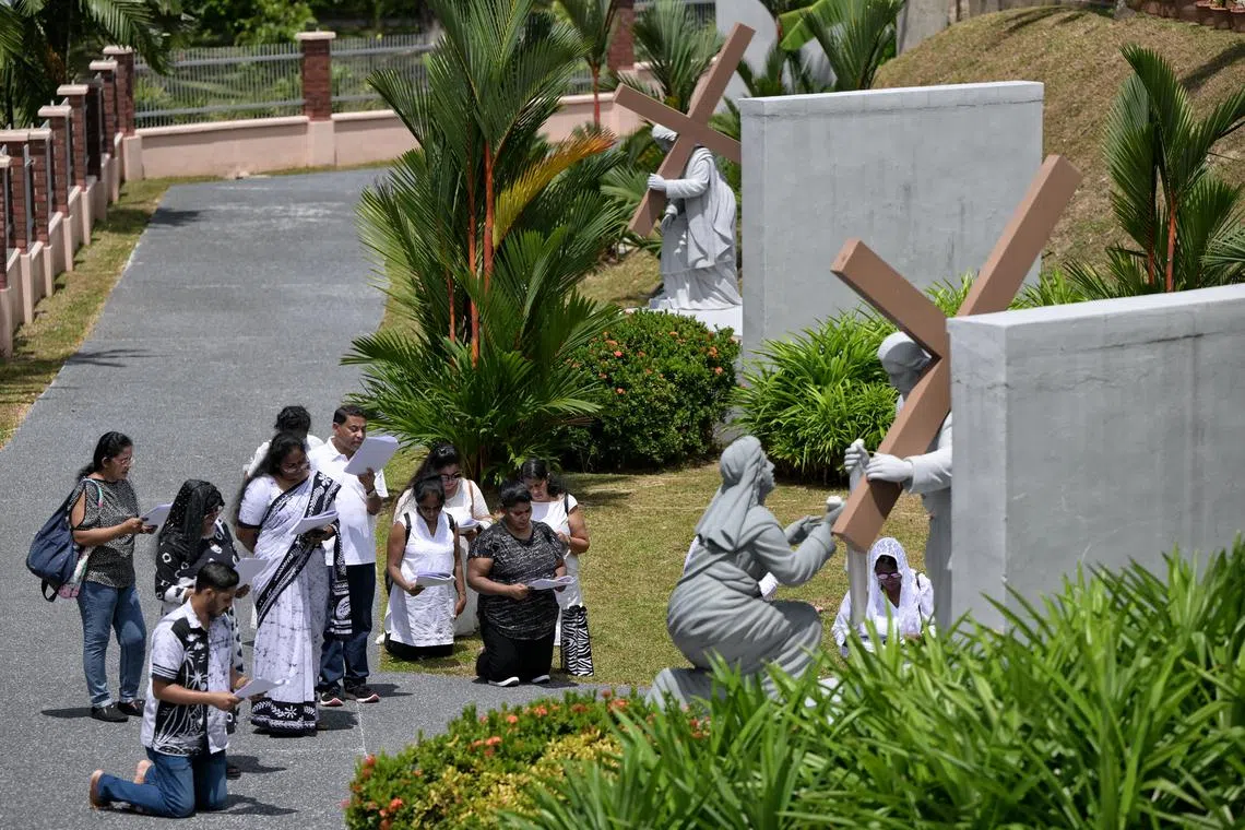 Worshippers from Church of St. Mary of the Angels praying along the Way of the Cross at St. Joseph's Church on Good Friday, March 29, 2024. The Way of the Cross is a special prayer across 14 stations, with each station depicting an event that took place during Jesus's journey to Mount Calvary where he was crucified. 