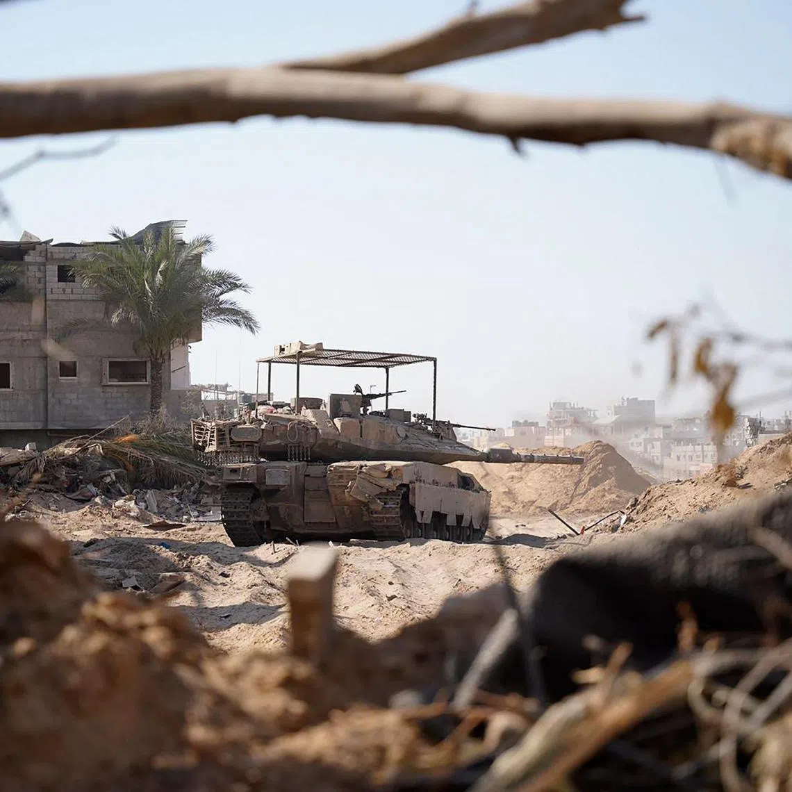 This handout picture released by the Israeli army shows an Israeli tank on the ground in the Gaza Strip on June 17, 2024, amid the ongoing conflict between Israel and the Palestinian militant group Hamas. (Photo by Israeli Army / AFP) / === RESTRICTED TO EDITORIAL USE - MANDATORY CREDIT "AFP PHOTO / Handout / Israeli Army' - NO MARKETING NO ADVERTISING CAMPAIGNS - DISTRIBUTED AS A SERVICE TO CLIENTS ==