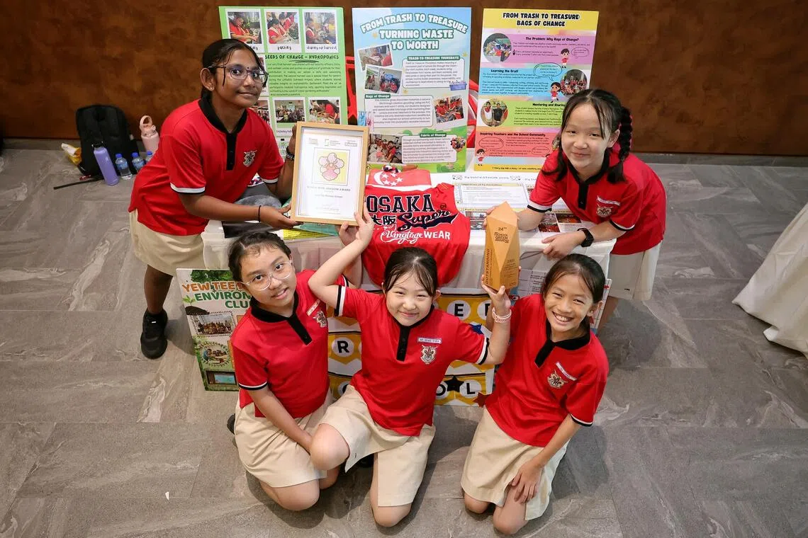Yew Tee Primary School pupils (from left) Ashmita Ahgilen, Lim Zhi Ning, Vivika Nie, Gu Chenxi and Khoo Ke Qi with their Vanda Miss Joaquim Award and Outstanding Environmental Achievement Award.