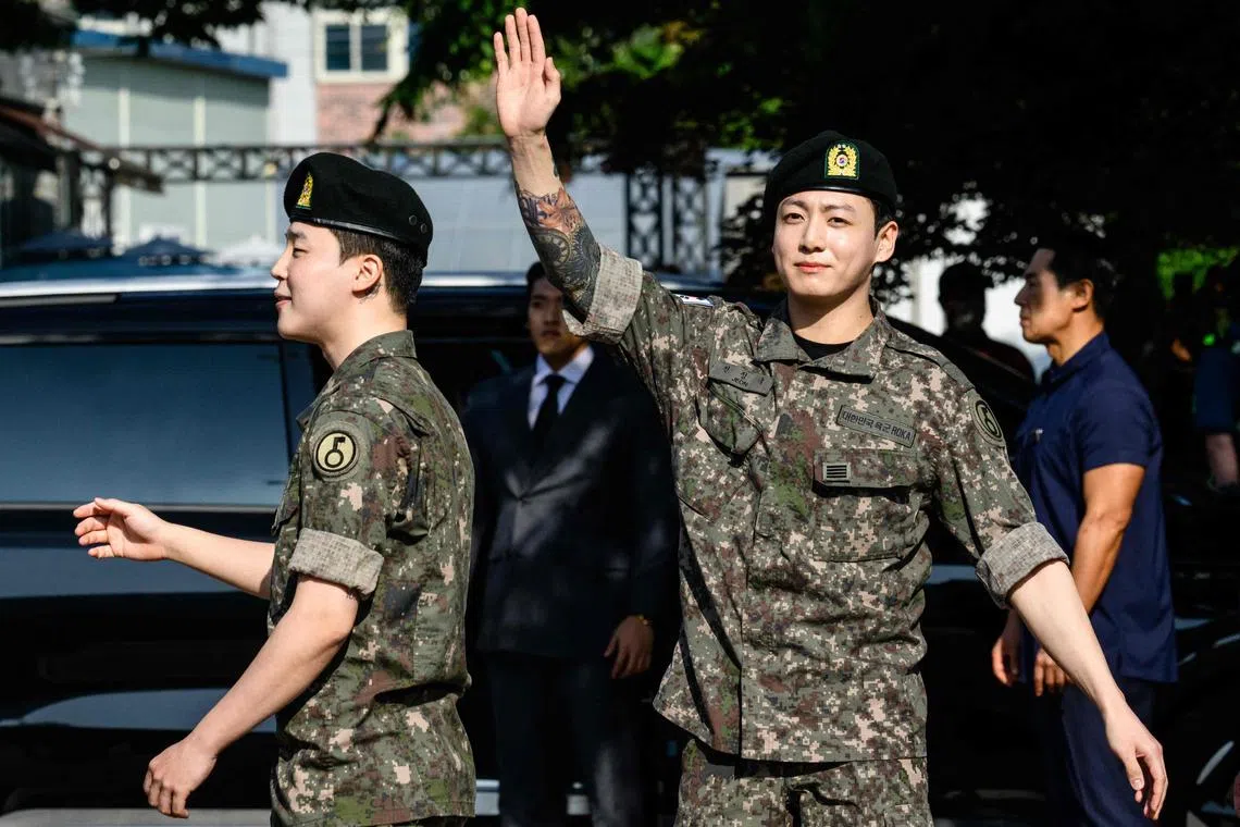 Jungkook of K-pop supergroup BTS waves as he departs from an outdoor sporting facility in Yeoncheon on June 11, 2025, shortly after his release from 18 months of South Korean military service. 