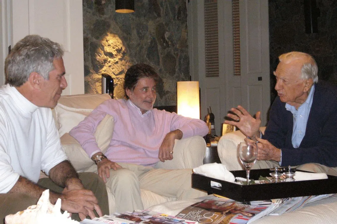 Former CBS news anchor Walter Cronkite speaks with late financier and convicted sex offender Jeffrey Epstein in an undated photograph released by the Department of Justice in Washington, D.C., U.S., on December 19, 2025 as part of a new trove of documents from its investigations into Epstein. U.S. Justice Department/Handout via REUTERS