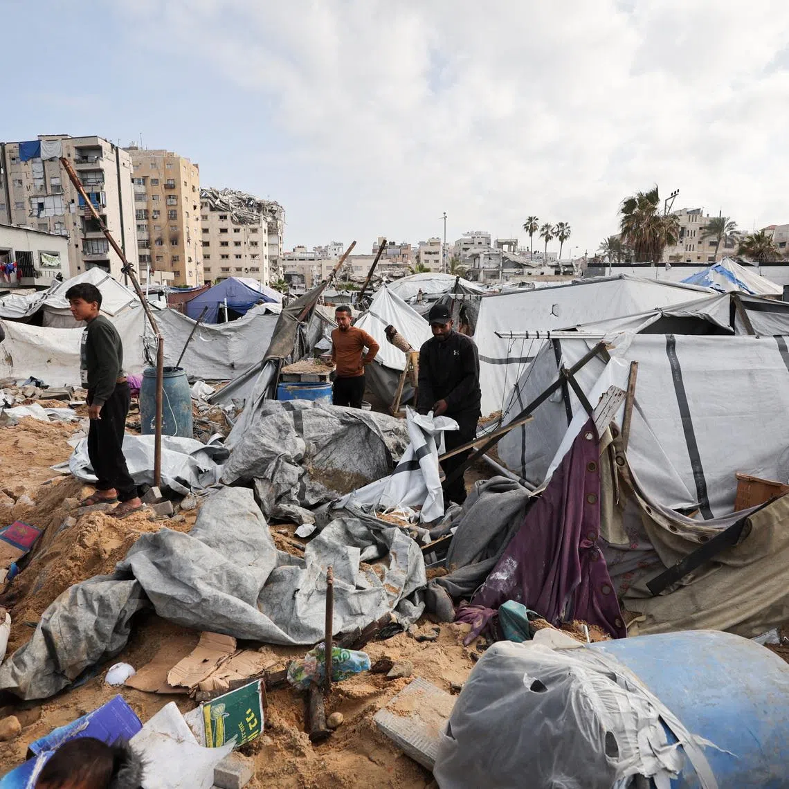 Palestinians inspect the site of Wednesday’s Israeli strike on a tent camp sheltering displaced Palestinians, in Gaza City, March 12, 2026. The Israeli military ordered the camp to evacuate before the strike. REUTERS/Dawoud Abu Alkas