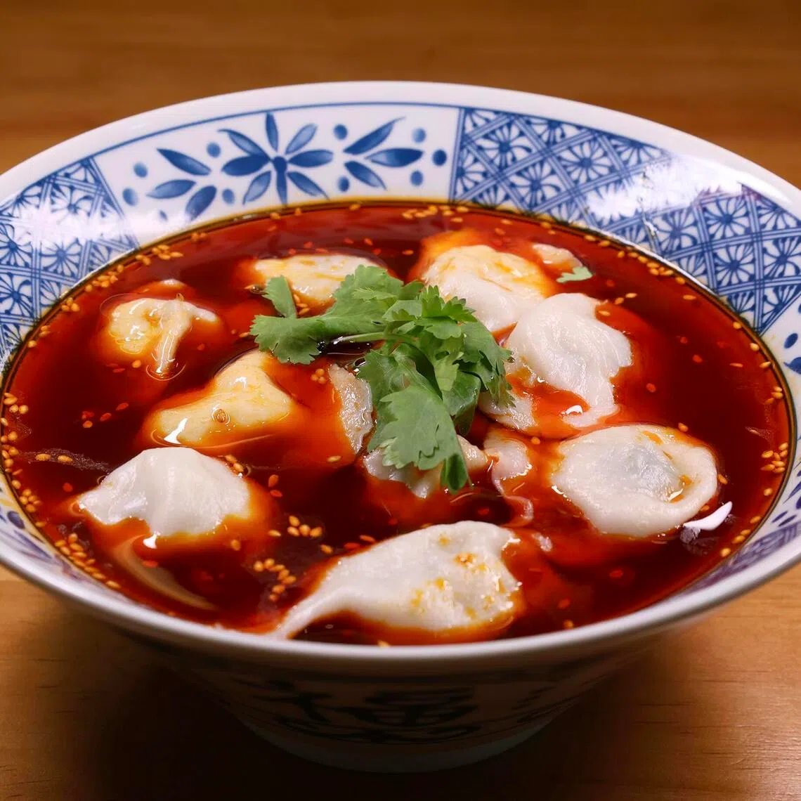 Fresh Chives With Pork Dumplings in Spicy Sour Soup Base at Chuxin Wonton.
