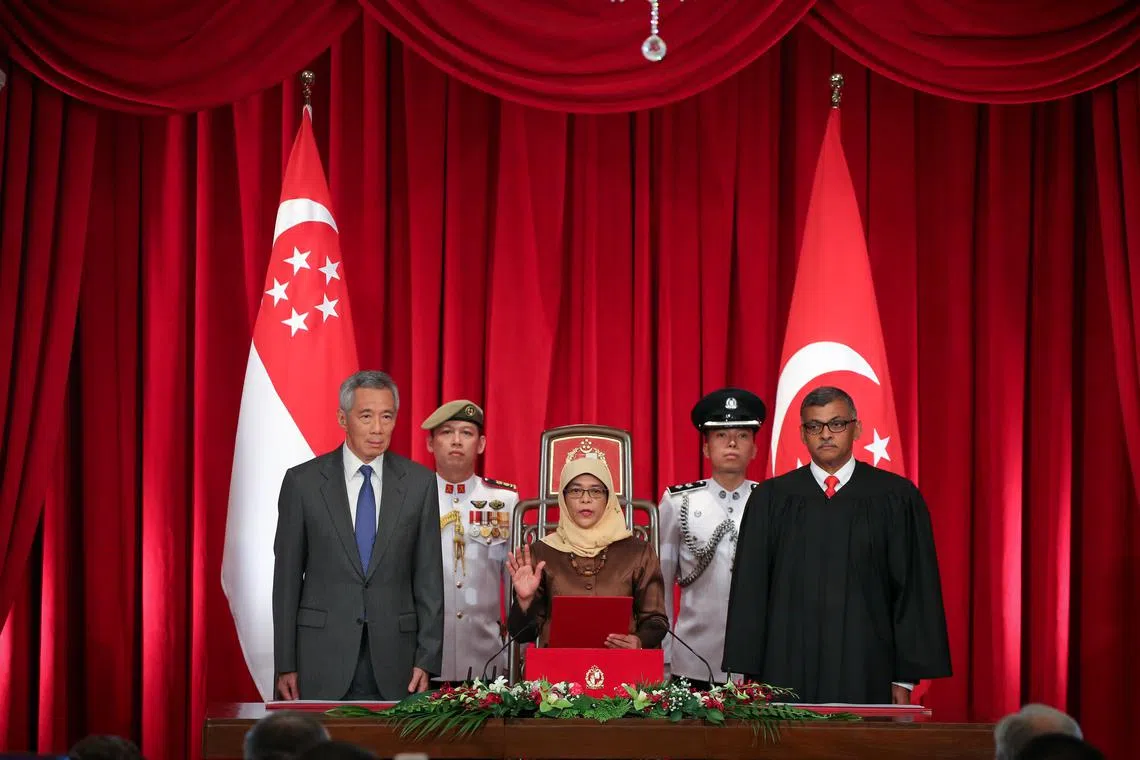 Madam Halimah Yacob, flanked by Prime Minister Lee Hsien Loong (left) and Chief Justice Sundaresh Menon, at her inauguration as the eighth President of Singapore at the Istana on Sept 14, 2017.