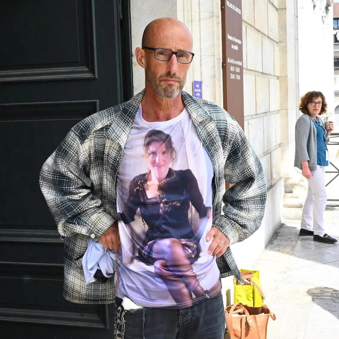 Mr Stephane Voirin, the partner of teacher Agnes Lassalle, wears a T-shirt honouring her memory on the first day of the trial, in Pau, southwestern France.