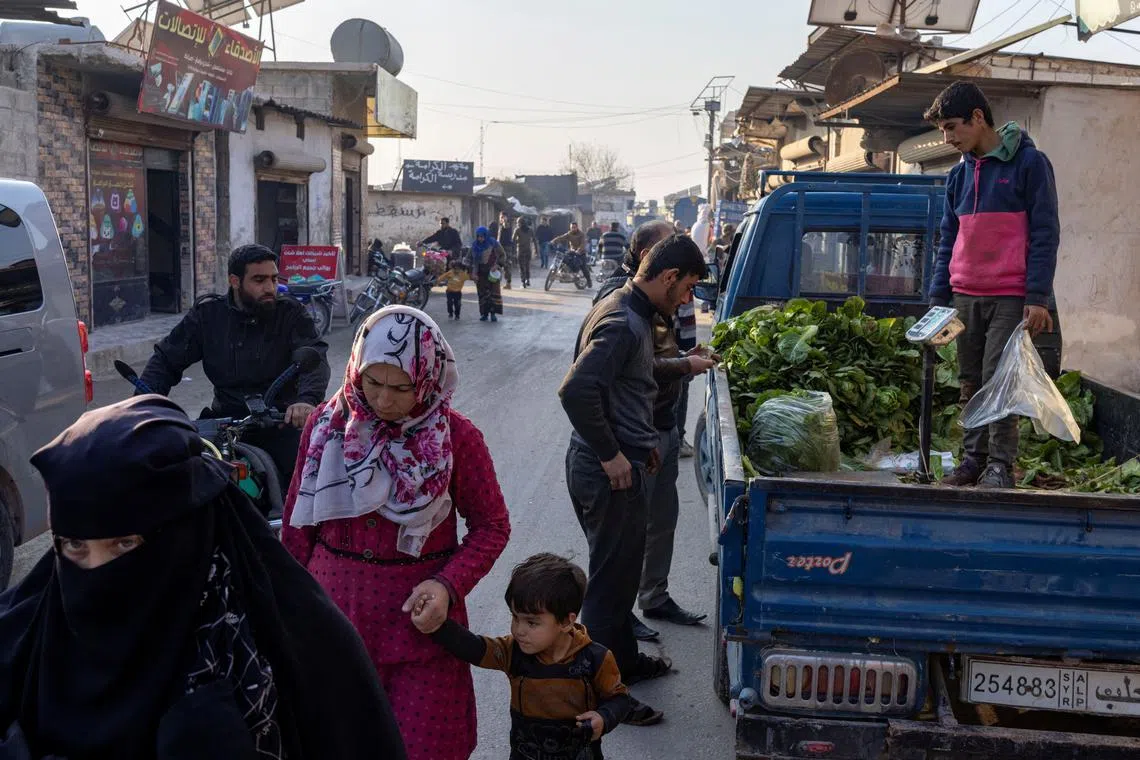 People walk along a street at a refugee camp in Idlib, a northwestern Syrian city where Hayat Tahrir al-Sham (HTS) had maintained an administration at the time when Syria's civil war front lines were frozen, Syria, December 17, 2024. REUTERS/Umit Bektas