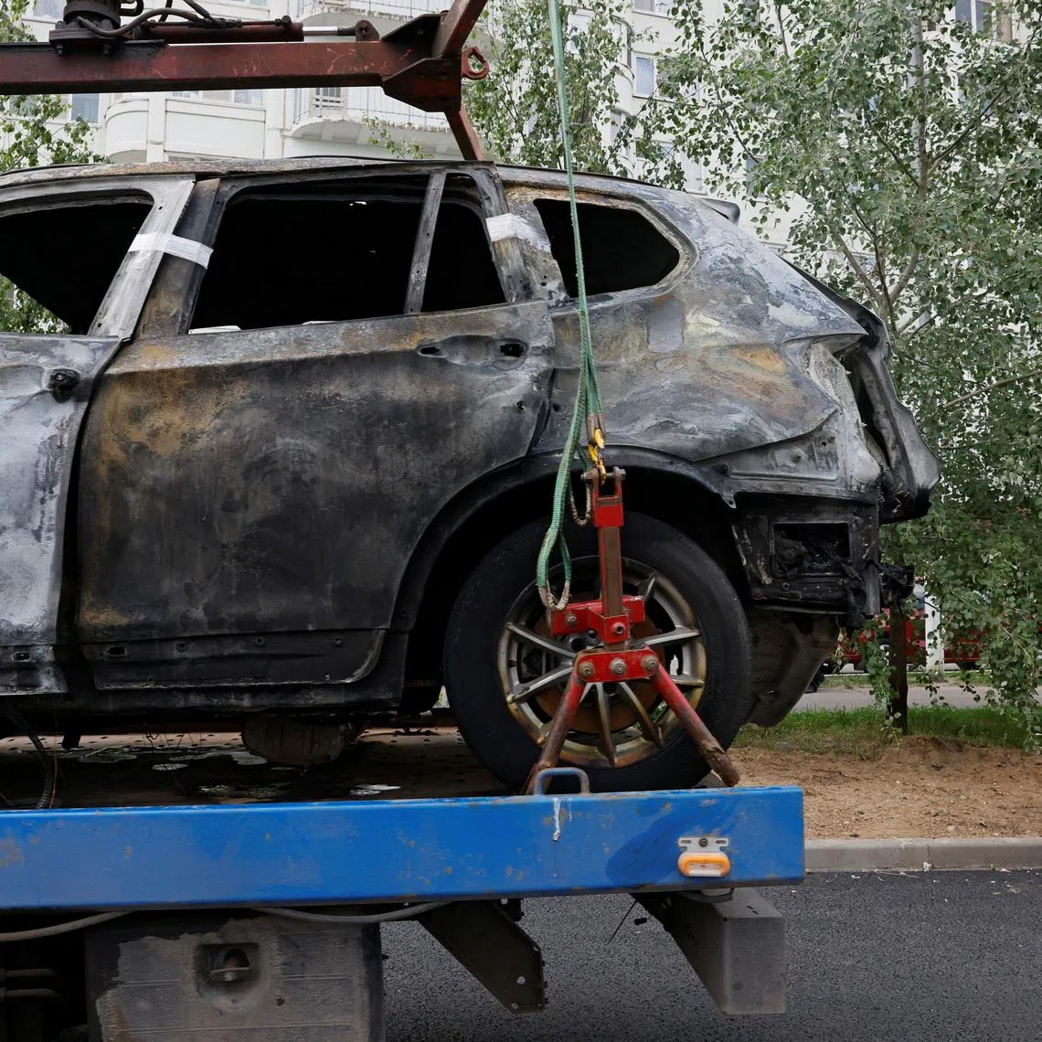 A wrecked car is being removed from the scene of a car explosion, which killed the driver, in the city of Balashikha in the Moscow region, Russia, June 9, 2026. REUTERS/Yulia Morozova