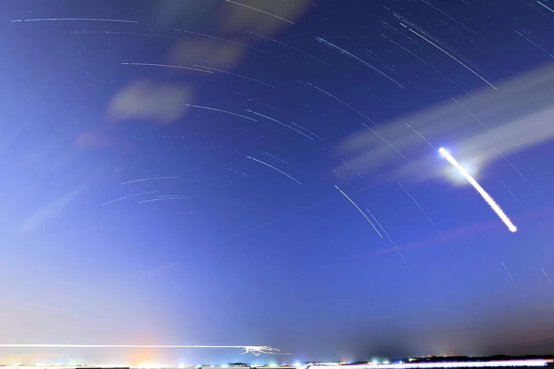 A digital composite overlay image of 153 photographs shows star trails over Changi Bay Point, taken during the Perseid meteor shower, on Aug 12, 2023.