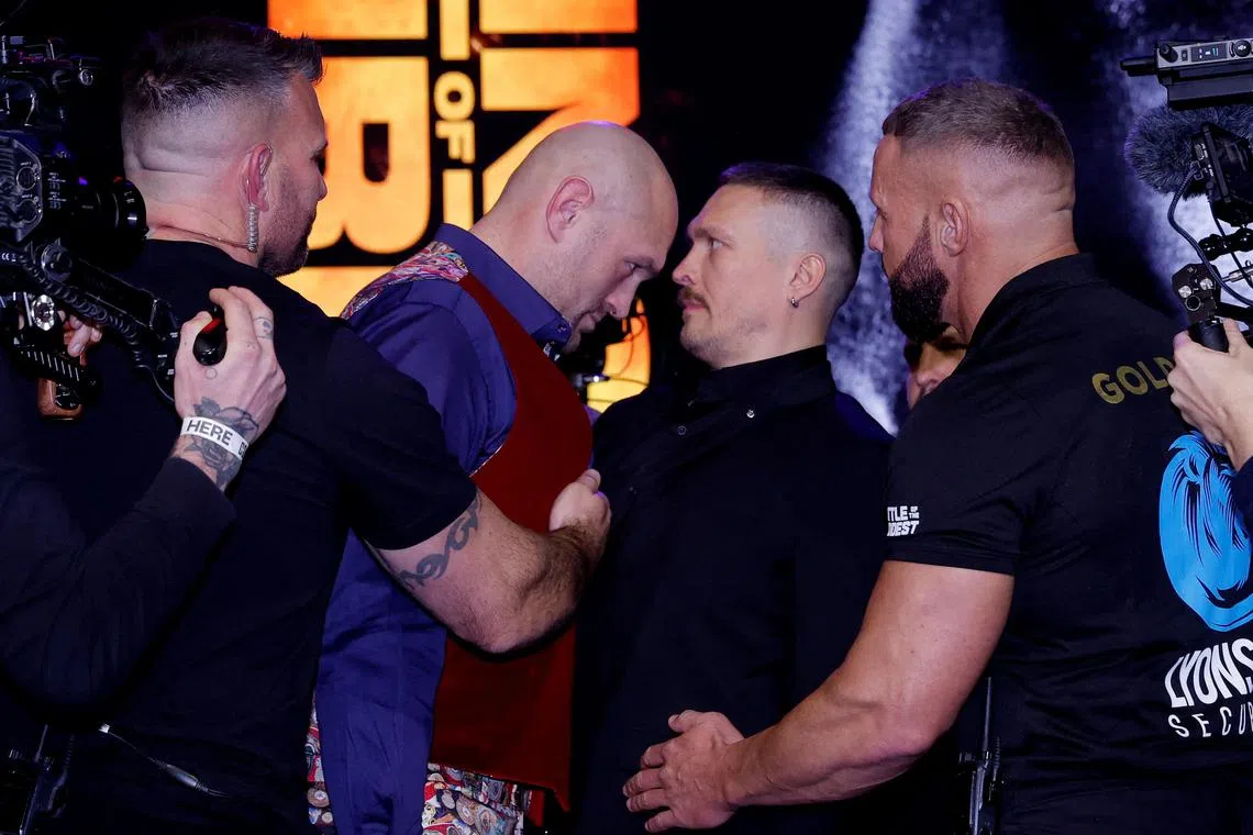 Tyson Fury and Oleksandr Usyk face off during the press conference to announce their mega fight on Feb 17.