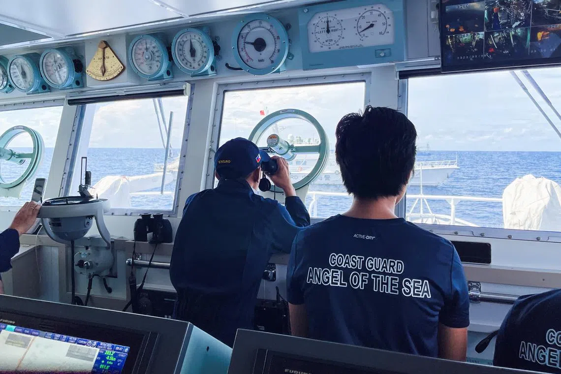 A Philippine Coast Guard checking on a China Coast Guard vessel in the South China Sea on Sept 8.