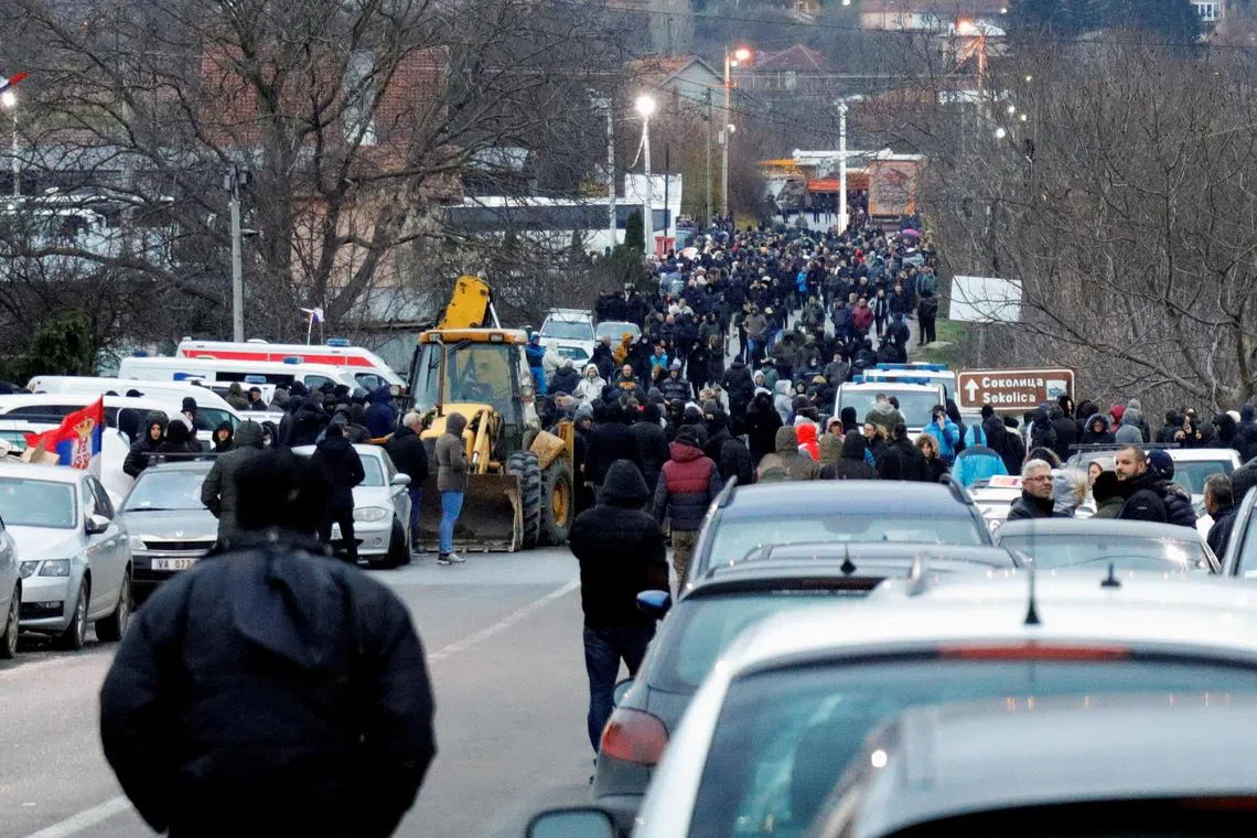 Kosovo Serbs block a road near the village of Rudine, in North Mitrovica, on Dec 10, 2022.