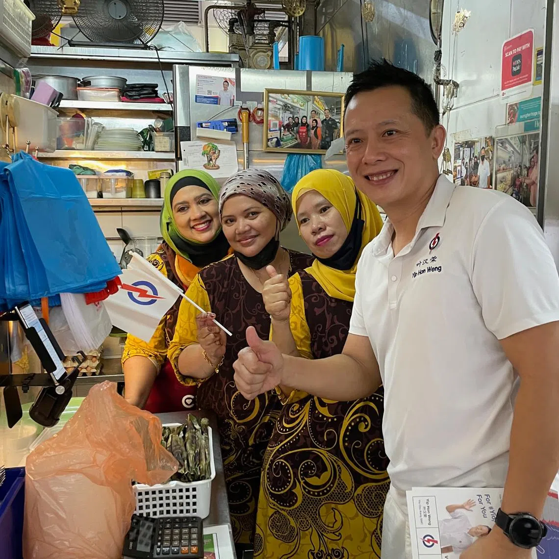 The PAP's Yio Chu Kang candidate Yip Hon Weng with hawkers during a walkabout at the market at Blk 628 Ang Mo Kio on April 29.