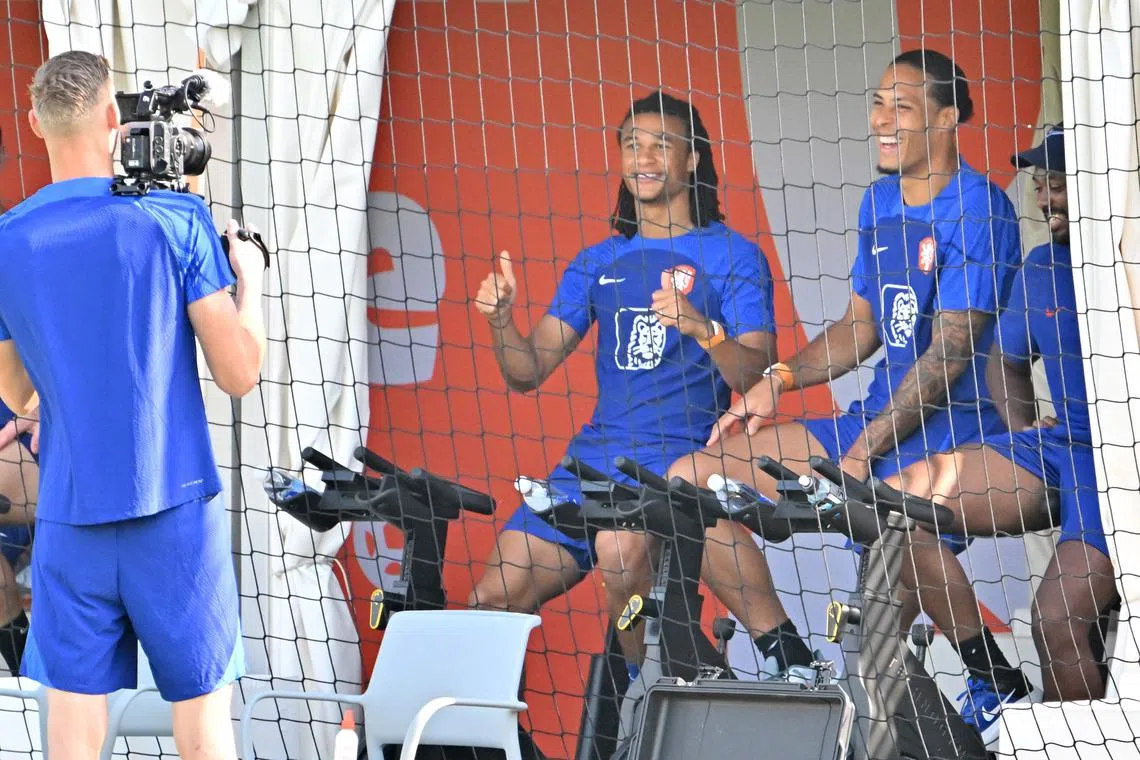 Netherlands' goalkeeper Andries Noppert "filming" teammates Nathan Ake and Virgil van Dijk during a training session on Dec 4.