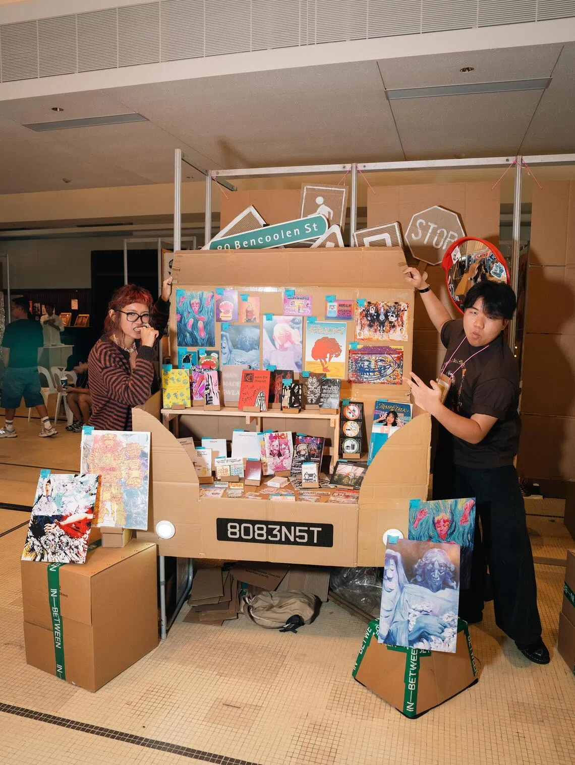 Group of art students 80 Ben St with their cardboard car booth at In-Between.