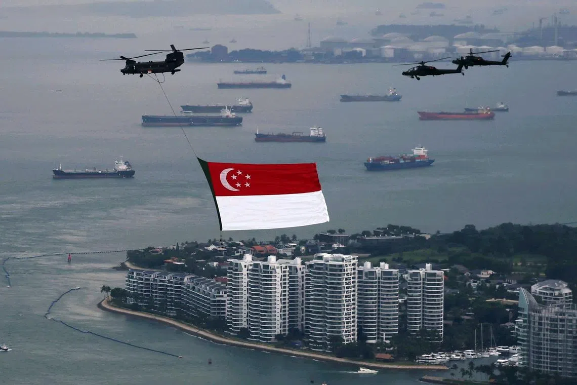 The CH-47 Chinook heavy-lift helicopter, escorted by two AH-64D Apache attack helicopters, waiting to make its entry towards National Stadium for the state flag fly-past rehearsal on July 4.