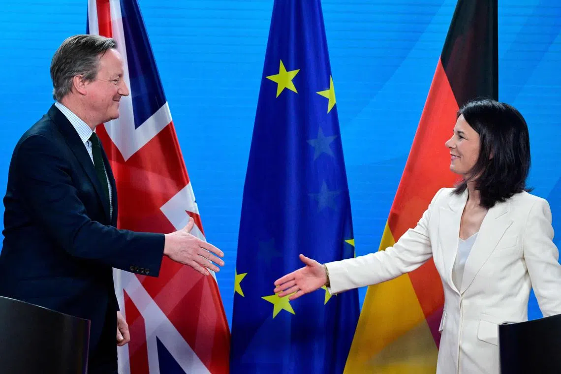 German Foreign Minister Annalena Baerbock (R) and Britain's Foreign Secretary David Cameron shake hands after addressing a press conference after the "German-British strategic dialogue" at the Foreign Ministry in Berlin, on March 7, 2024. (Photo by Tobias SCHWARZ / AFP)