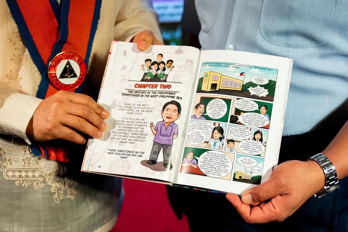 National Security Adviser Eduardo Ano and Philippine Coast Guard Spokesperson for the South China Sea Jay Tarriela hold a copy of the book \"The Stories of Teacher Jun\" during its launch at the National Library of the Philippines in Manila, Philippines, January 24, 2025. REUTERS/Lisa Marie David