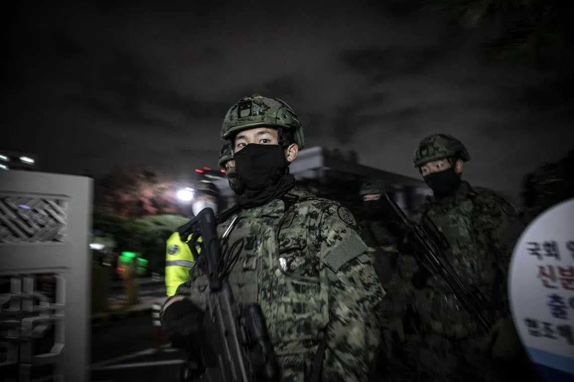 Armed South Korean soldiers leave the National Assembly on Dec 4, as South Korea's parliament votes to defy President Yoon Suk Yeol’s declaration of martial law.
