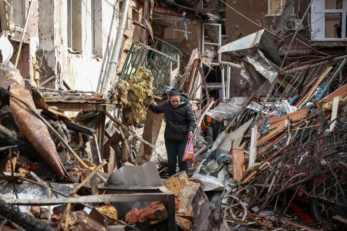 A resident walks at the site of an apartment building hit by a Russian drone strike, amid Russia's attack on Ukraine, in Odesa, Ukraine, April 24, 2026. REUTERS/Nina Liashonok