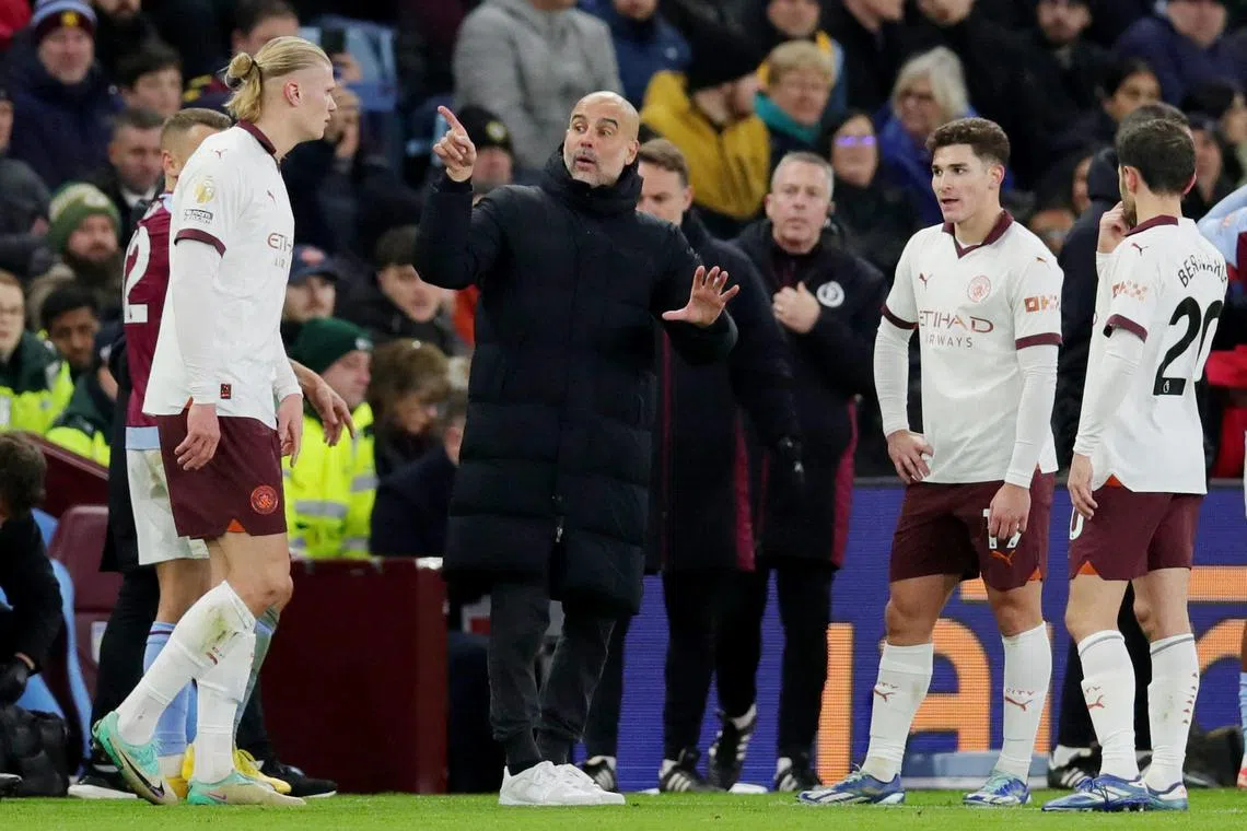 Manchester City manager Pep Guardiola speaking to his players during the 1-0 English Premier League defeat by Aston Villa.