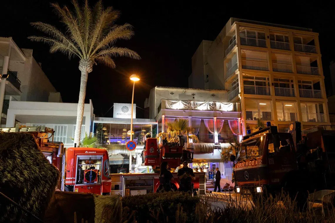 Ambulance and firefighters vehicles are seen after a two-storey building collapsed in Playa de Palma, south of the Spanish Mediterranean island's capital Palma de Mallorca, on May 23.