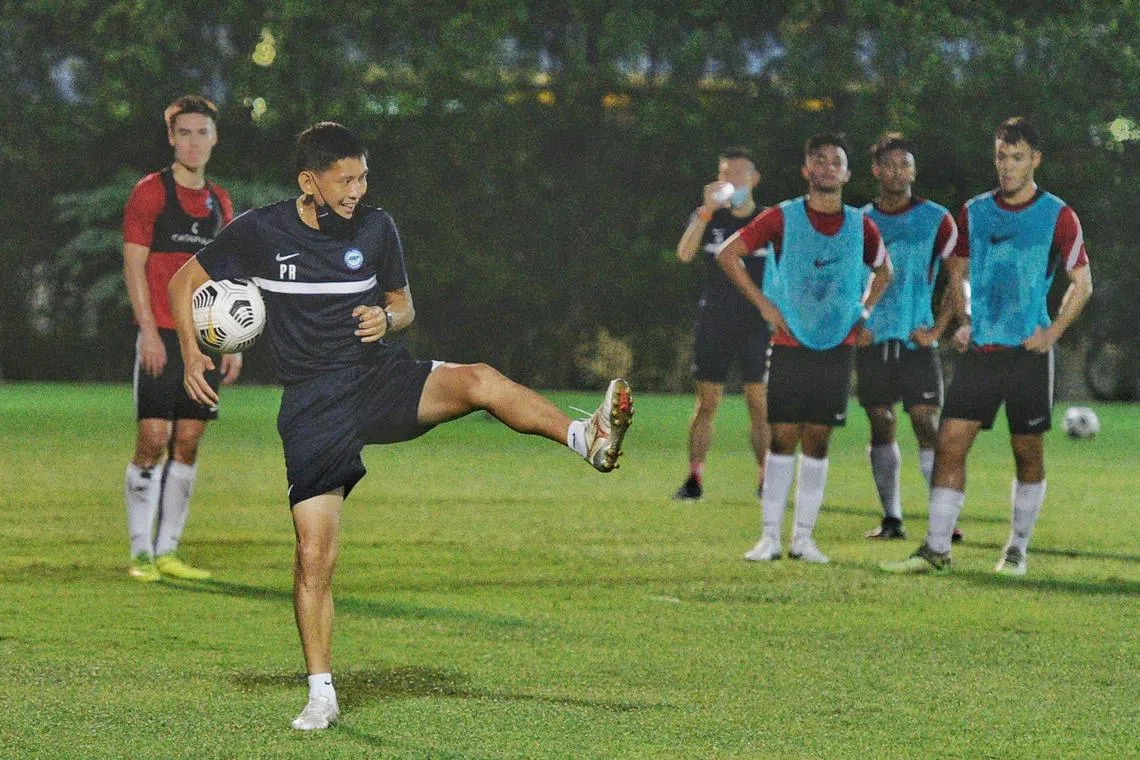 Head Coach Philippe Aw giving instructions to the players of the Singapore under 22 football team at Geylang field on October 23, 2021. 