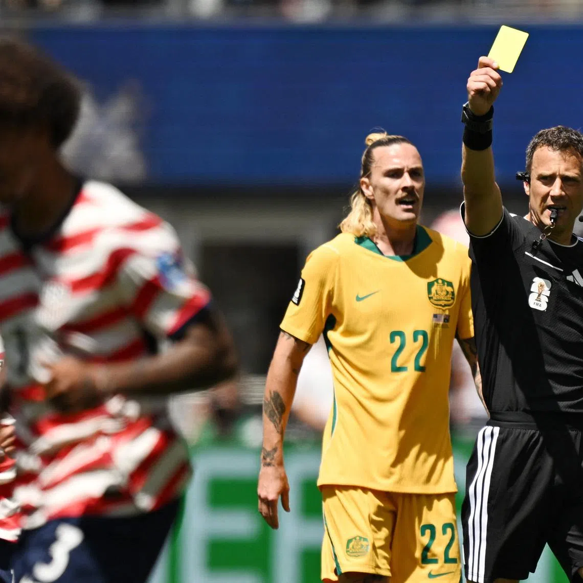 Soccer Football - FIFA World Cup 2026 - Group D - United States v Australia - Seattle Stadium, Seattle, Washington, U.S. - June 19, 2026 Referee Felix Zwayer shows a yellow card to Chris Richards of the U.S. as Australia's Jackson Irvine looks on IMAGN IMAGES via Reuters/Troy Wayrynen