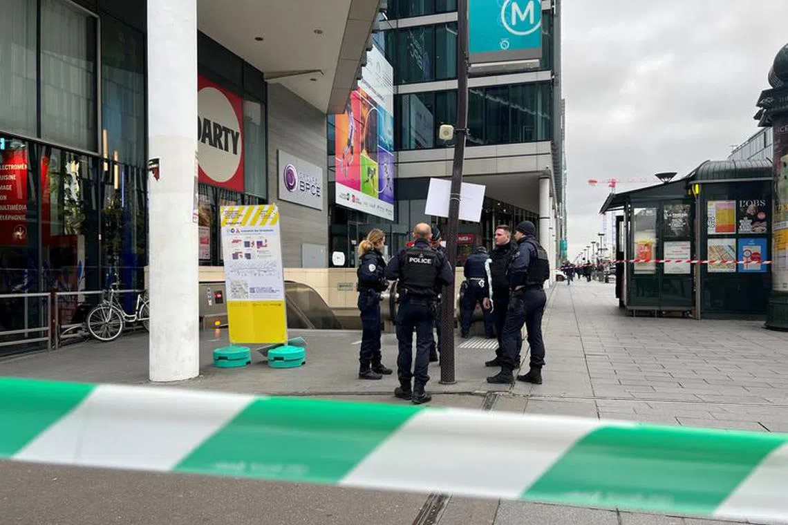 Police stand outside the Bibliotheque Francois Mitterand metro and regional train station, where officers shot and injured a woman wearing a hijab after she shouted \"Allahu Akbar\" and \"You're all going to die\", in Paris, France, October 31, 2023. REUTERS/Lucien Libert