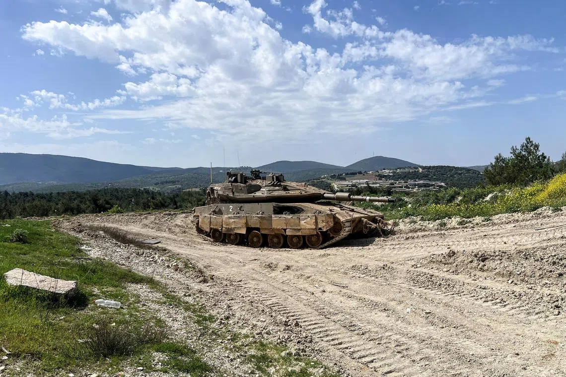 An Israeli tank is positioned on the Israeli side of the Israel-Lebanon border, March 18, 2025 REUTERS/Avi Ohayon