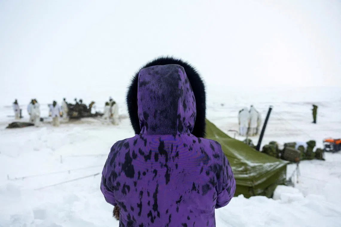 FILE PHOTO: A resident watches as the 1st Regiment, Royal Canadian Horse Artillery works with an M777 Howitzer as Canadian Armed Forces deploy to 'Operation Nanook-Nunalivut', a yearly series of drills designed to highlight the military’s ability to defend the Canadian Arctic, in Cambridge Bay, Nunavut, Canada February 19, 2026. REUTERS/Carlos Osorio/File Photo