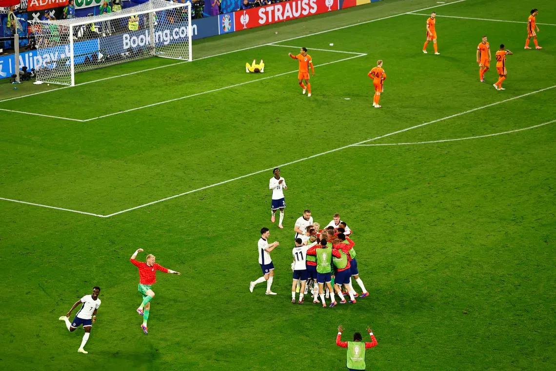 FILE PHOTO: Soccer Football - Euro 2024 - Semi Final - Netherlands v England - Dortmund BVB Stadion, Dortmund, Germany - July 10, 2024  England's Ollie Watkins celebrates scoring their second goal with teammates as Netherlands players look dejected REUTERS/Leon Kuegeler/File Photo