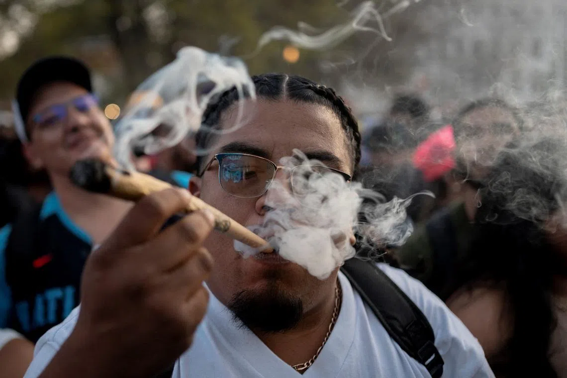 A reveller smokes cannabis at the Mile High 420 Festival in Denver, Colorado, U.S., April 20, 2026.  REUTERS/Cheney Orr