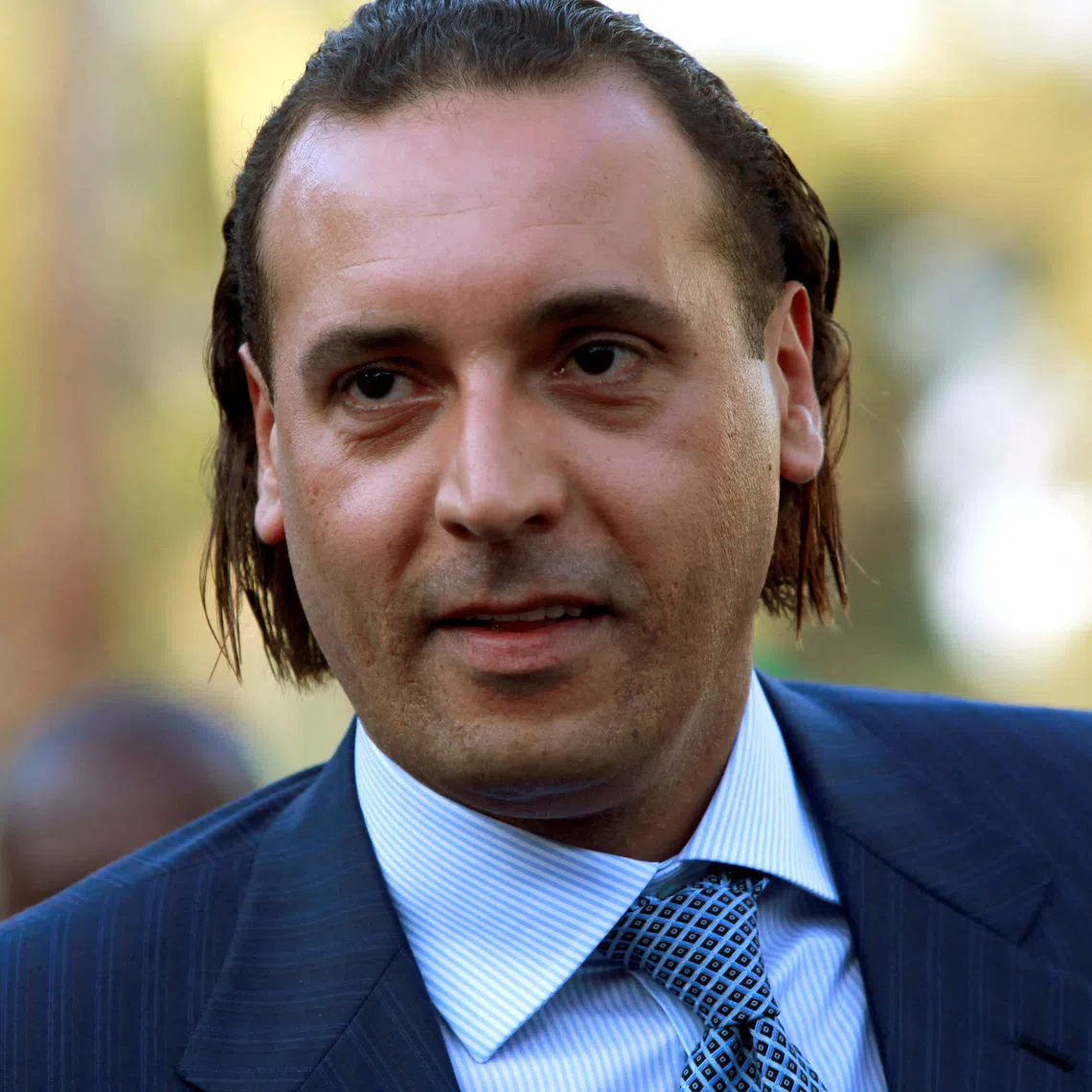FILE PHOTO: Hannibal Gaddafi, son of Libyan leader Muammar Gaddafi, attends the signing agreement ceremony between Libya's Shipping Corporation and STX Europe to build a cruise ship, in Tripoli June 30, 2010.  REUTERS/Ismail Zitouny/File Photo