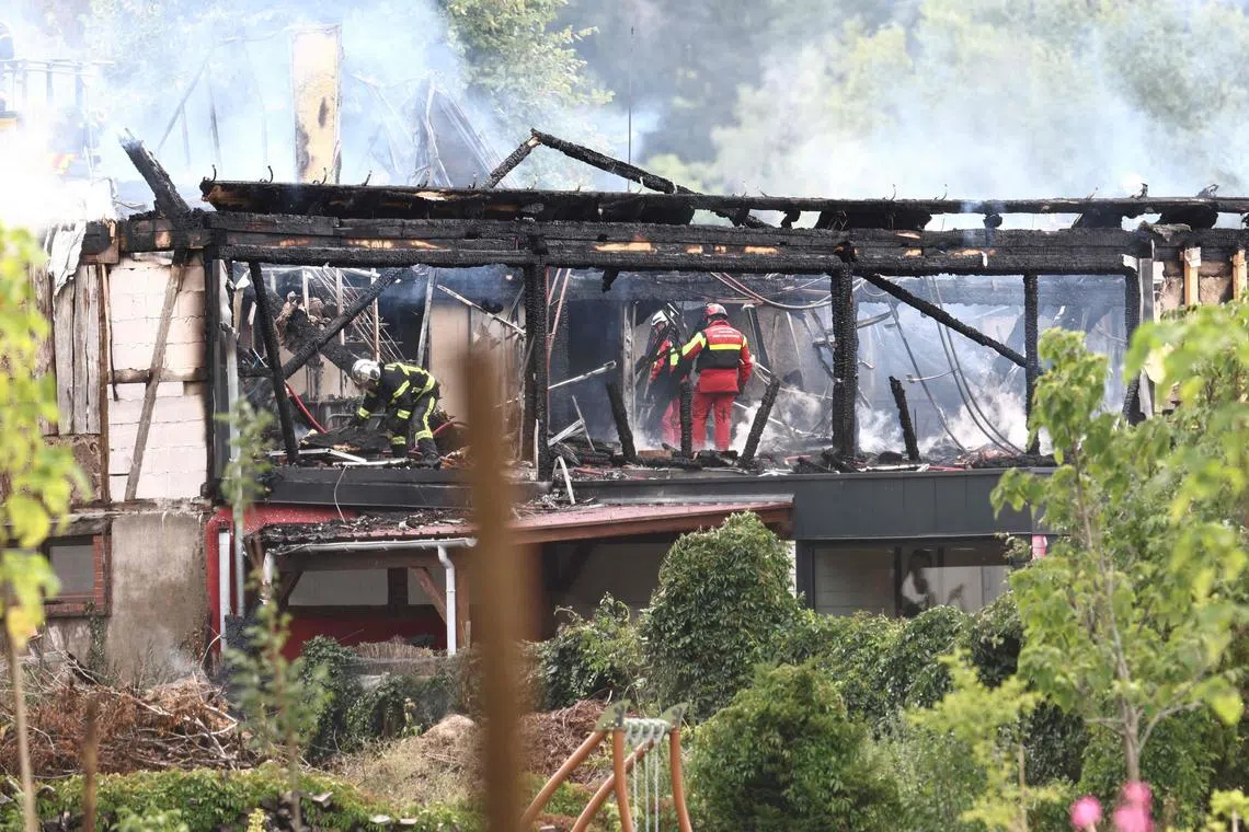 TOPSHOT - Firefighters inspect a burnt building after a fire erupted at a holiday home for disabled people in Wintzenheim, eastern France, on August 9, 2023. Eleven people were missing following a fire at a centre, where a group of adults with learning disabilities were taking their holidays, authorities said. Seventeen people were safely evacuated, with one person hospitalised and another treated for shock. (Photo by Sebastien BOZON / AFP)