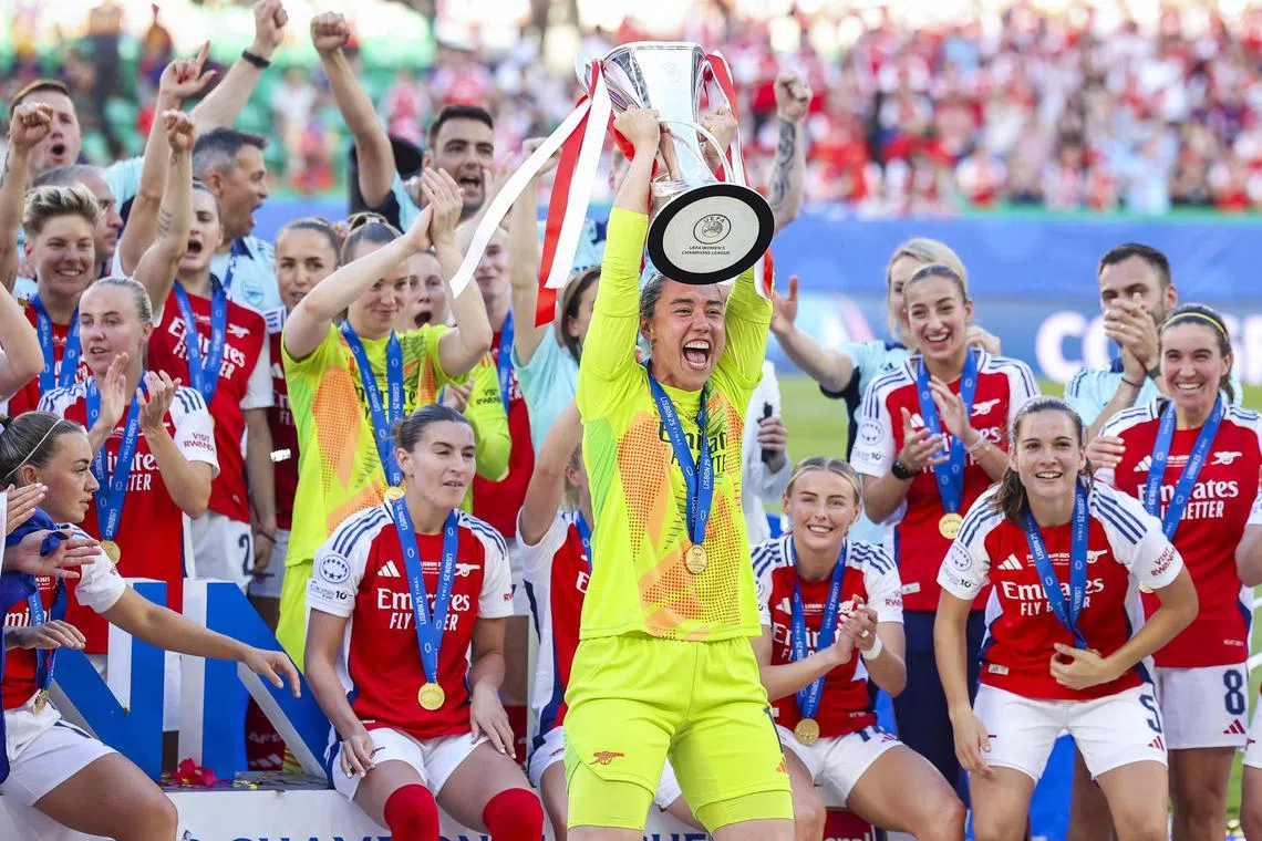 Arsenal`s players celebrating with the trophy  after winning the Uefa Women's Champions League final against Barcelona on May 24.