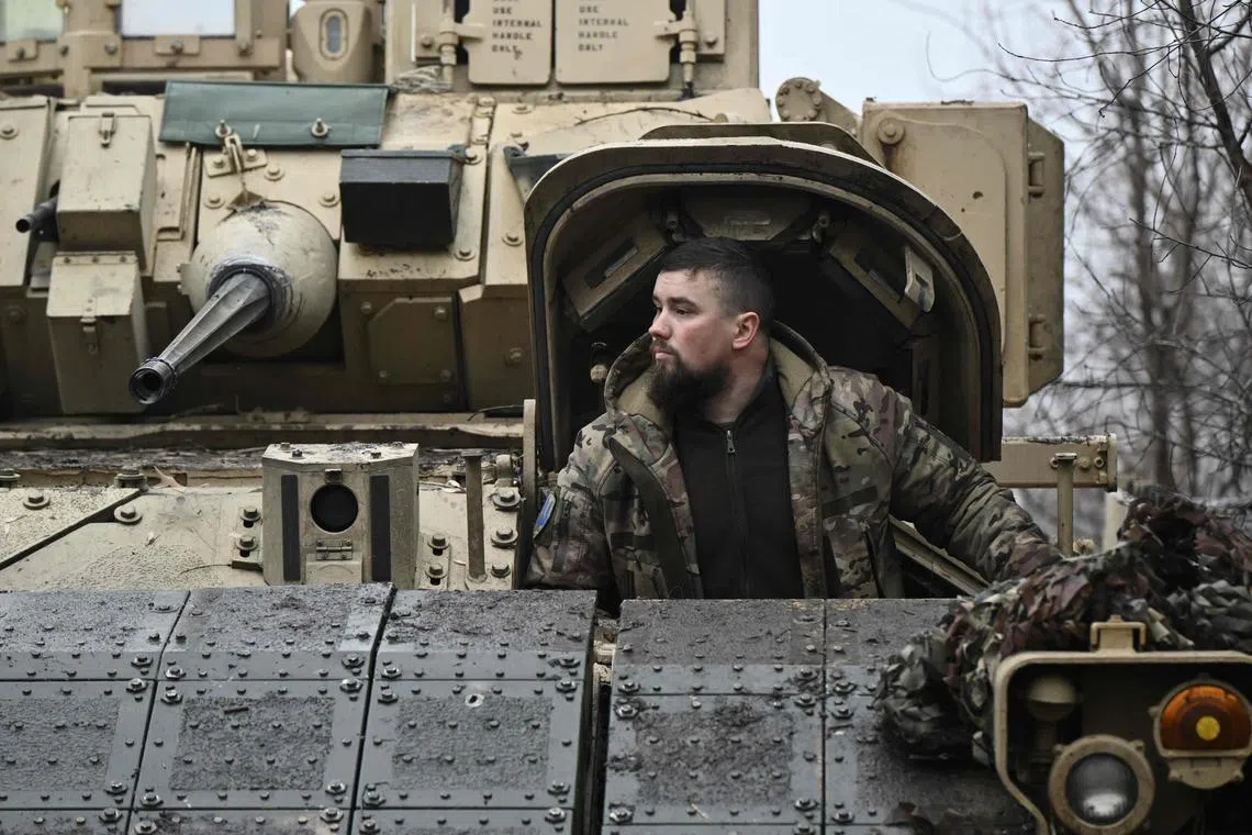 A Ukrainian serviceman of the 47th Mechanized Brigade prepares for combat in a Bradley fighting vehicle, not far from Avdiivka, in Ukraine's Donetsk region.