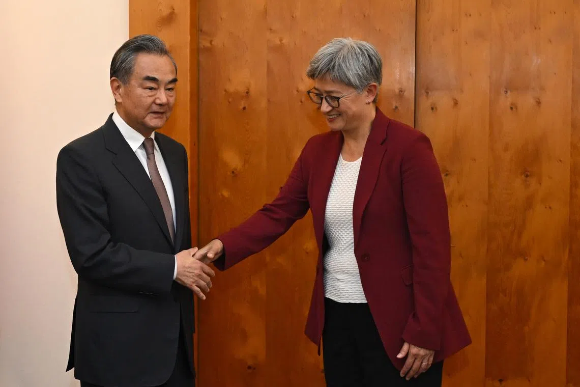 Australian Foreign Minister Penny Wong (right) shakes hands with Chinese Foreign Minister Wang Yi during a meeting at Parliament House in Canberra, Australia, on March 20, 2024.  