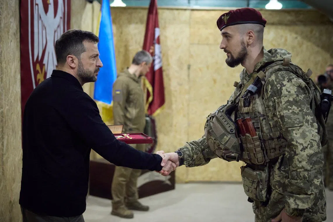 Ukrainian President Volodymyr Zelensky presenting awards to soldiers during his Oct 4 visit to Ukraine's Sumy region, which borders Russia.