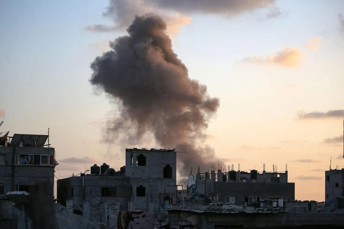 Smoke rising as Israeli troops target a building in the Nuseirat refugee camp, in the central Gaza Strip, on Aug 22.