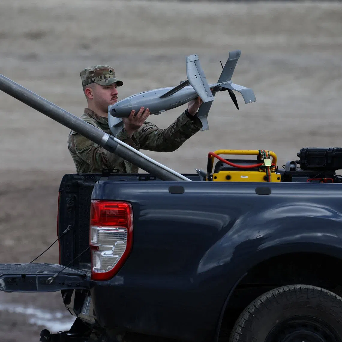 A U.S. soldier installs an AS3 interceptor, part of a modular American-made AI-powered counter-drone system, MEROPS on the back of a truck during a presentation at a polygon in Nowa Deba, Poland, November 18, 2025. REUTERS/Kacper Pempel