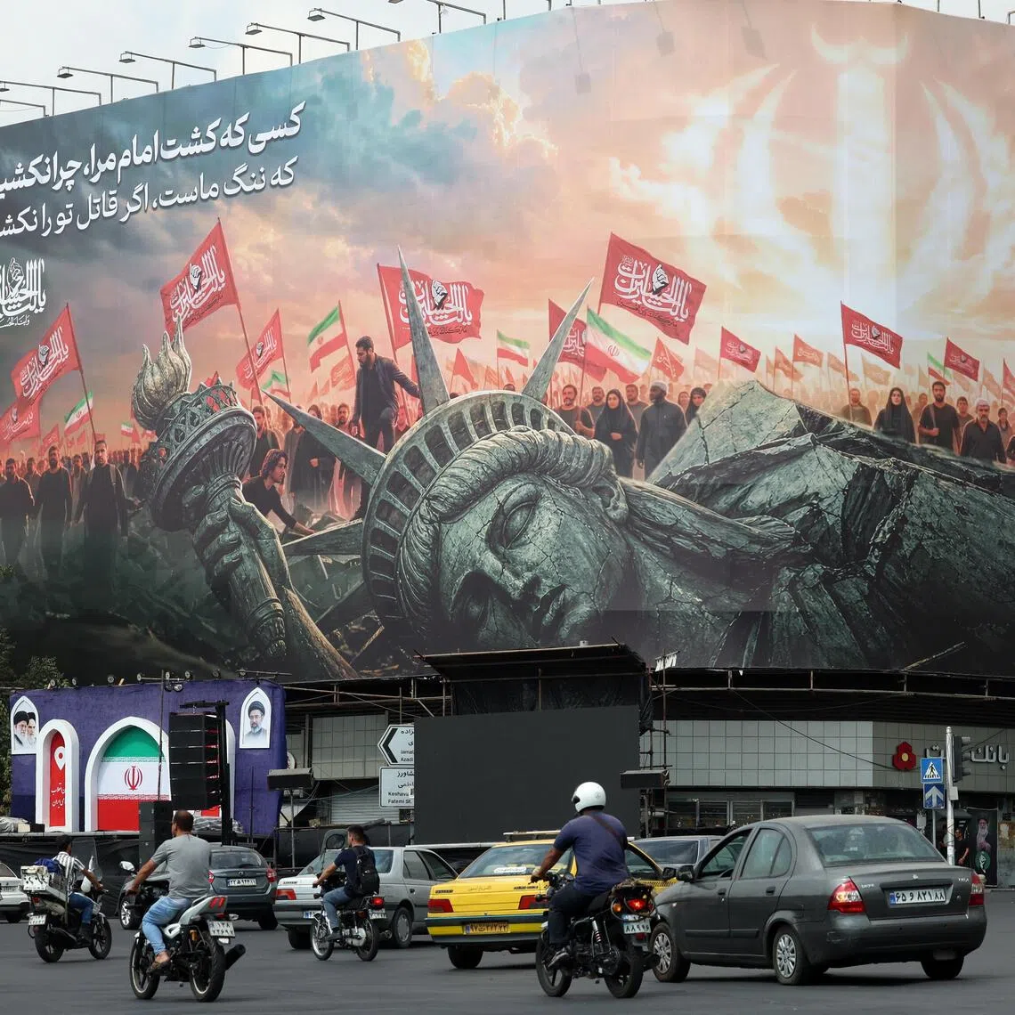 Iranians driving past an anti-US billboard in Tehran, Iran, on Sept 9.
