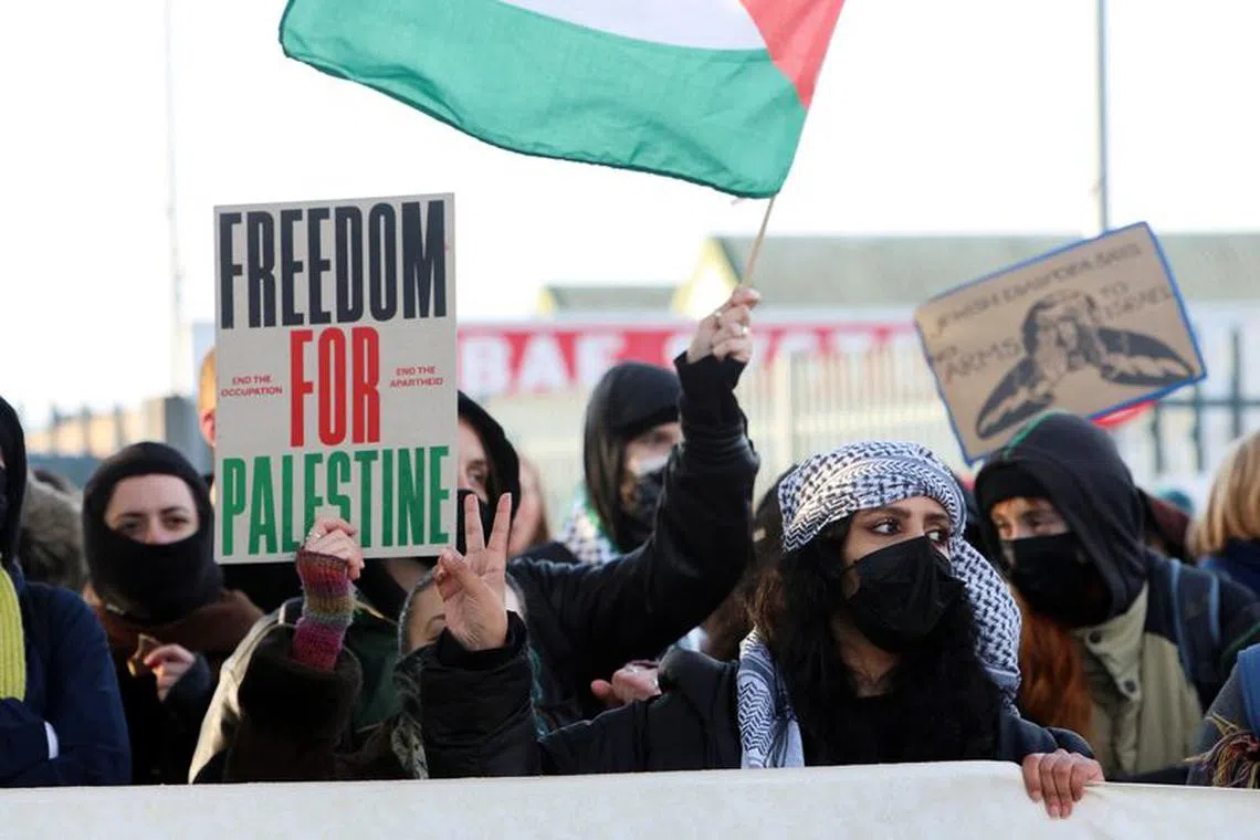 A woman gestures, as protestors and trade unionists blockade BAE Systems Rochester, during a protest in support of Palestinians in Gaza, amid the ongoing conflict between Israel and the Palestinian Islamist group Hamas, in Rochester, Kent, Britain, November 10, 2023. REUTERS/Susannah Ireland