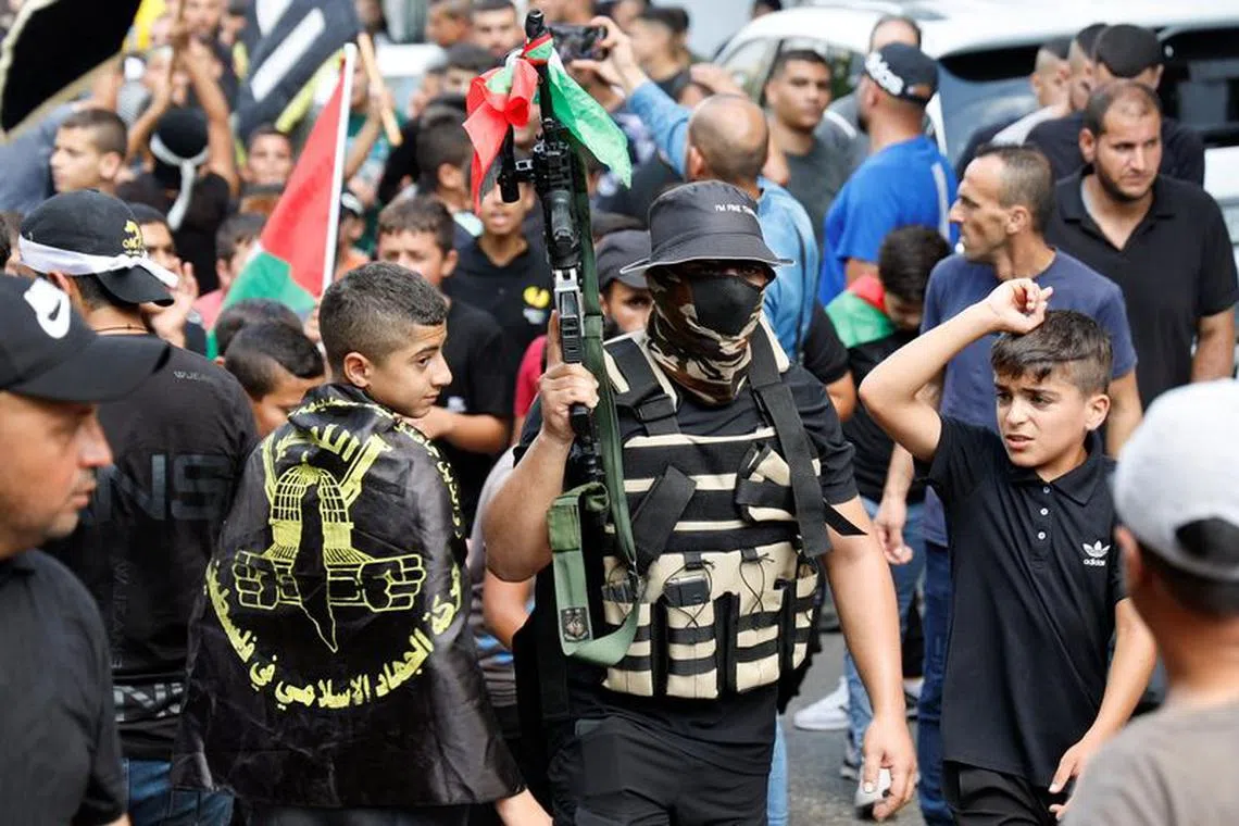 Gunmen attend the funeral of Abdullah Abu Hassan, a Palestinian who was killed in an Israeli raid, in Al-Yamoun near Jenin, in the Israeli-occupied West Bank September 22, 2023. REUTERS/Raneen Sawafta